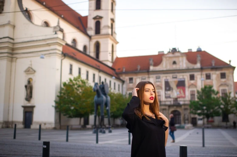 Woman in front of historic buildings