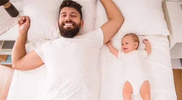 Father and baby in bed