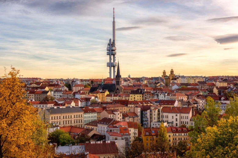 Pohled na Prahu s televizní věží v pozadí při západu slunce.