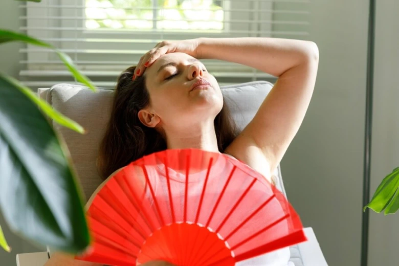Woman fanning herself from heat