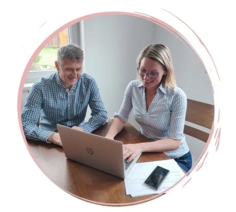 Two people working on laptop