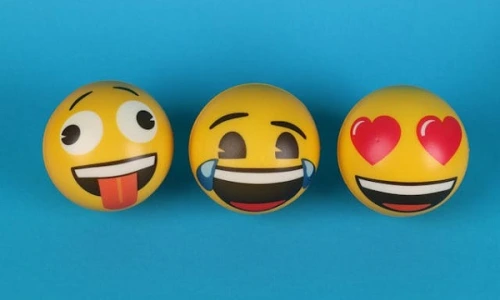 Three emoji balls on blue background