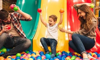 Family playing in ball pit
