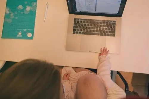 Baby and laptop at desk