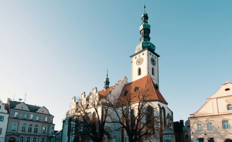 Historická kostelní věž v českém městském náměstí.
