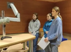 Three women in a room with medical equipment