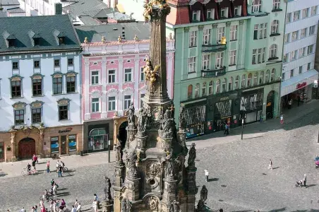 Sloup svatého Václava na náměstí v Olomouci s barevnými domy.