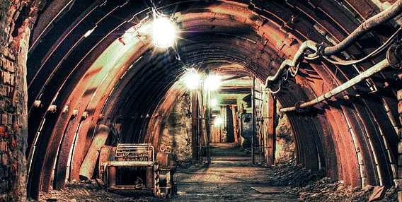 Zaniklý důlní tunel v okolí Ostravy s rzi a starými stroji.